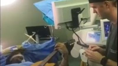 فنان يعزف على الجيتار أثناء خضوعه لجراحة بالمخ