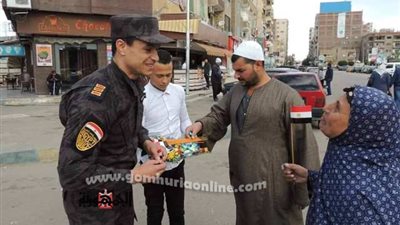 رجال الشرطة يوزعون ورود وحلويات احتفالا بعيدها في الإسماعيلية.صور